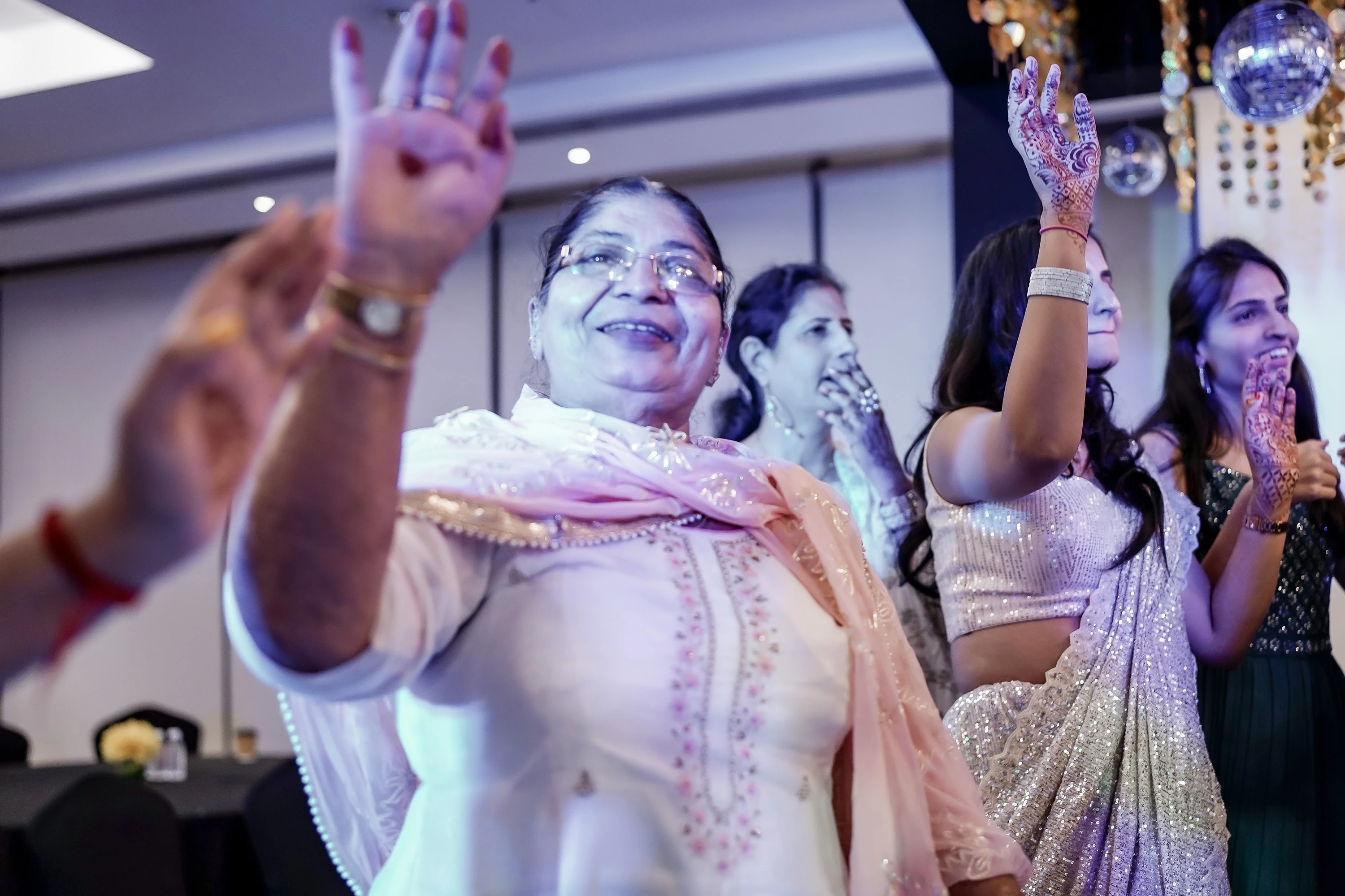 Family members enjoying music together at a sangeet celebration