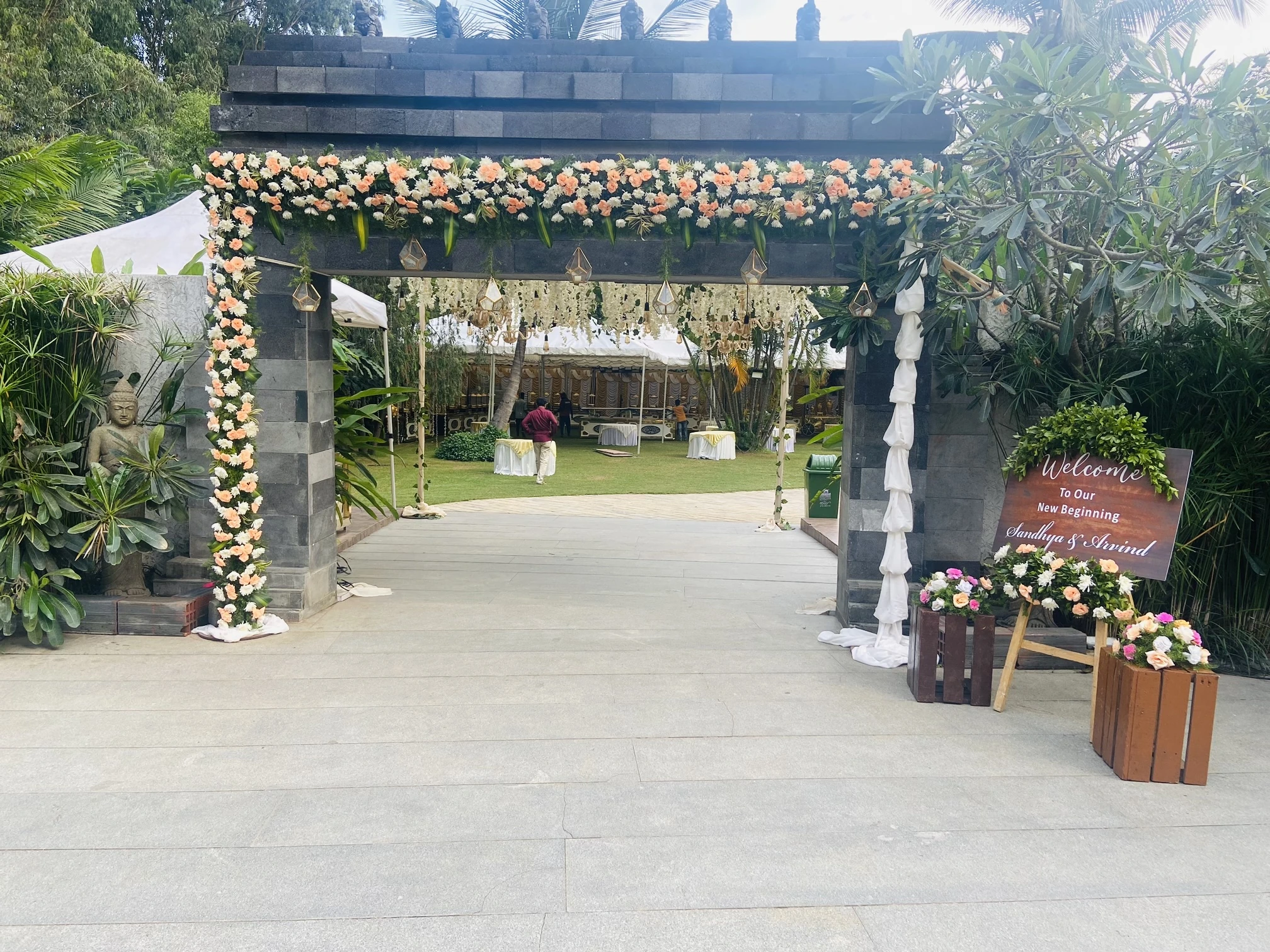 A floral entrance canopy leading into a garden venue