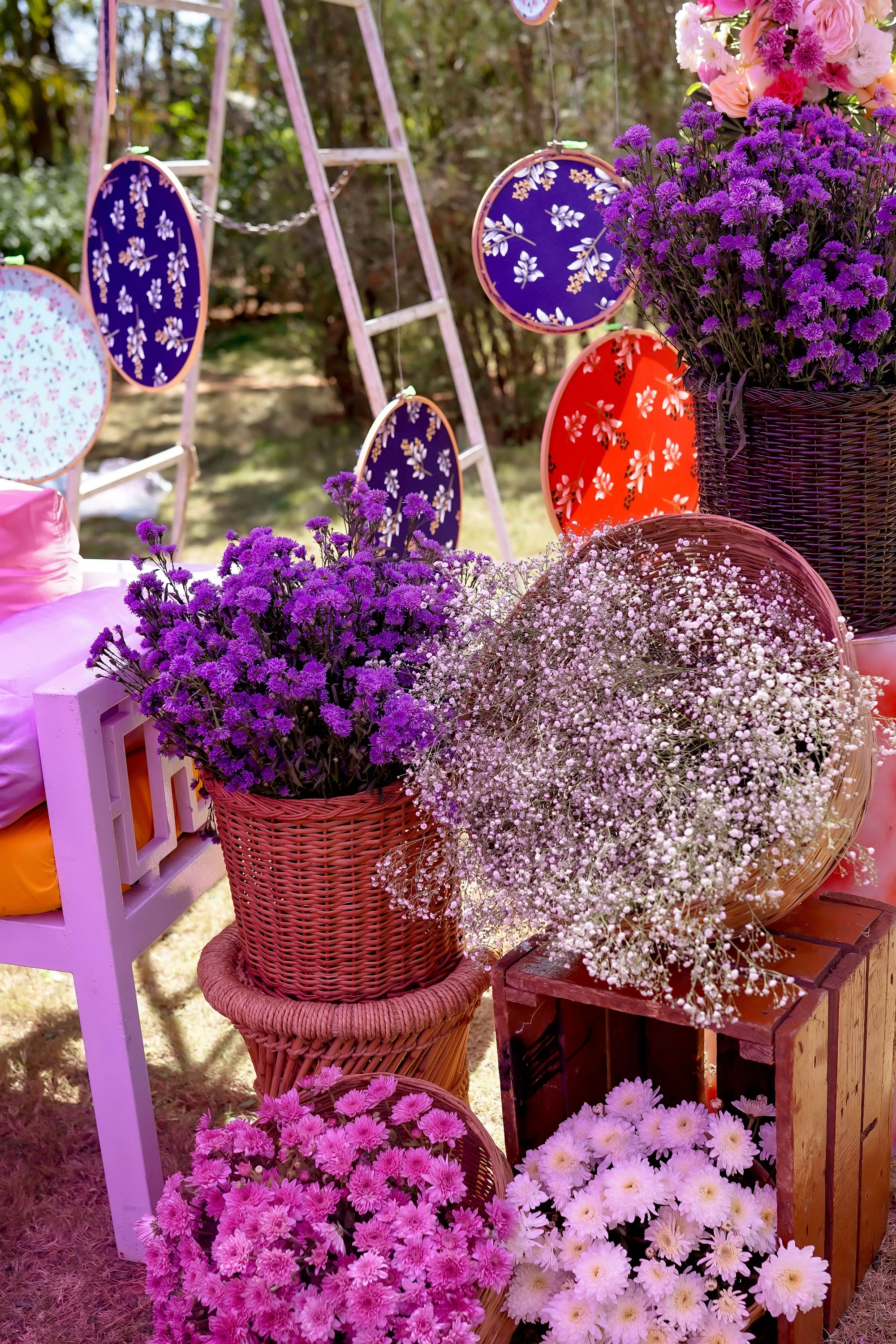 Patterned cushions and flower baskets at a colourful mehendi corner
