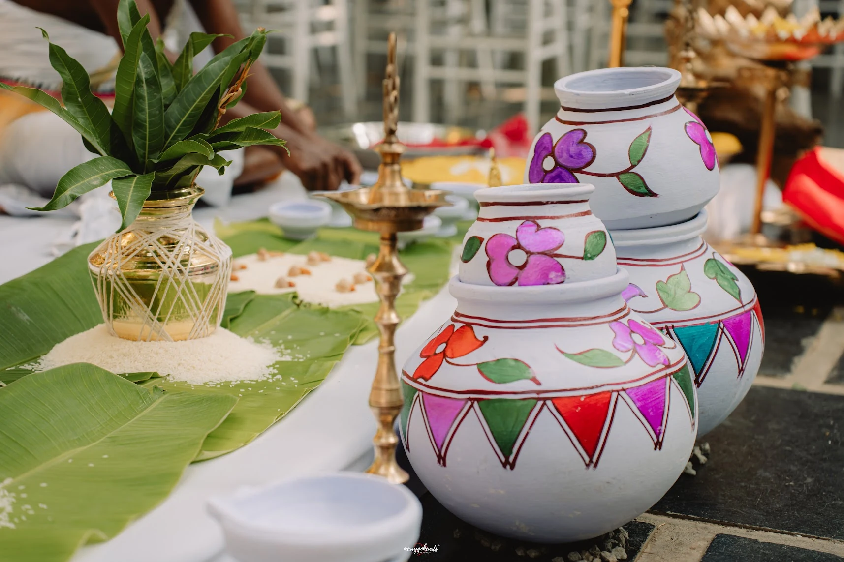Painted ceremonial vessels, brass lamps and offerings arranged for the wedding
