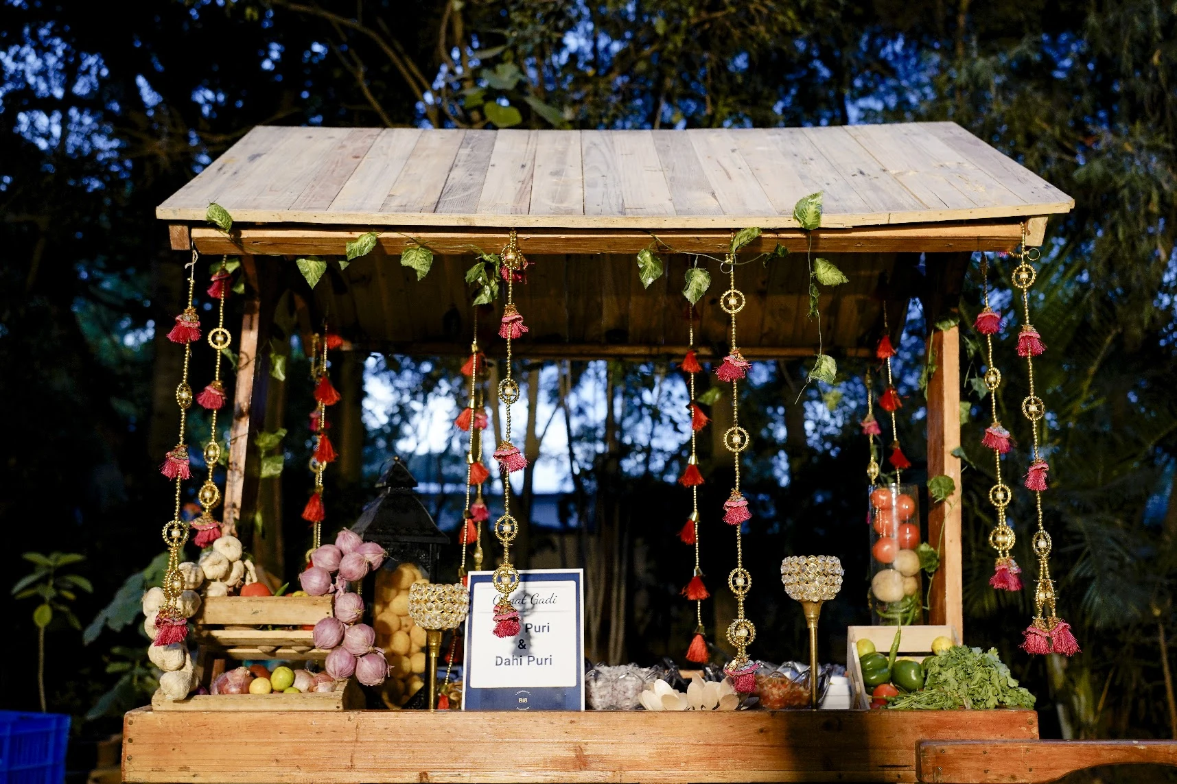 A decorated chaat counter with pani puri, dahi puri and fresh ingredients.