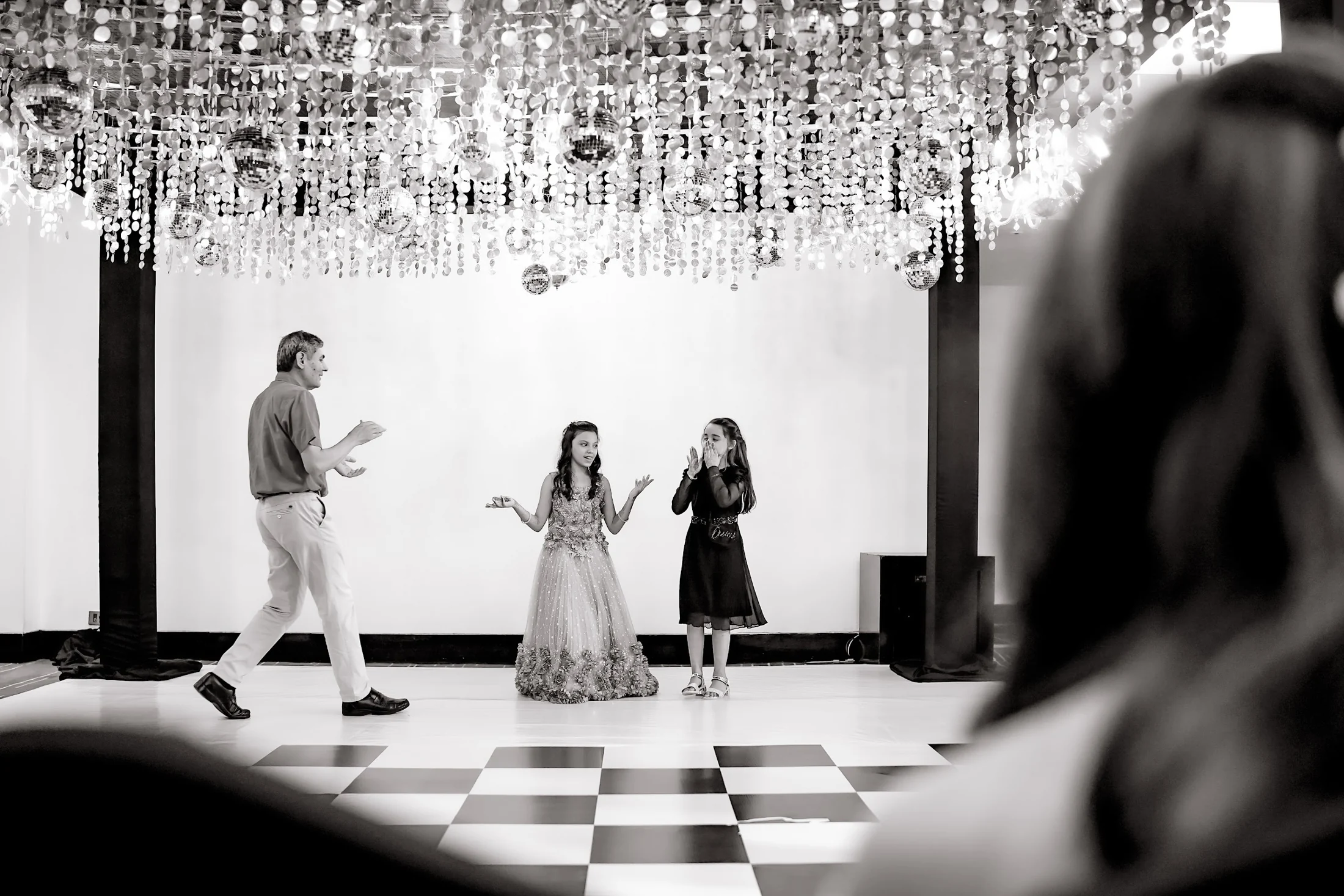 Family and guests performing together on a celebration dance floor