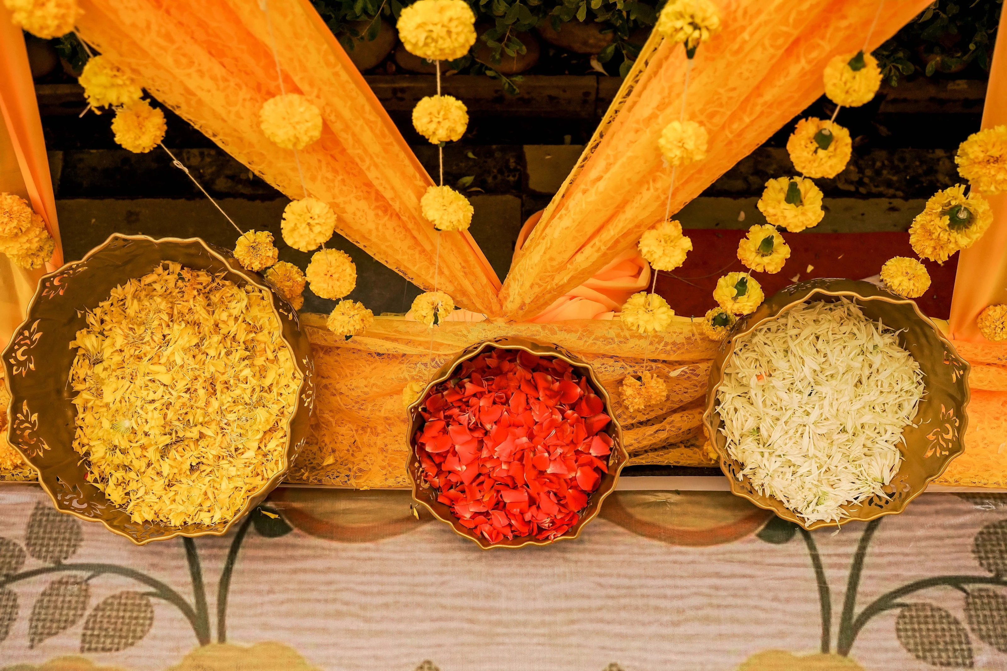Yellow drapes, marigold garlands and baskets of colourful flowers