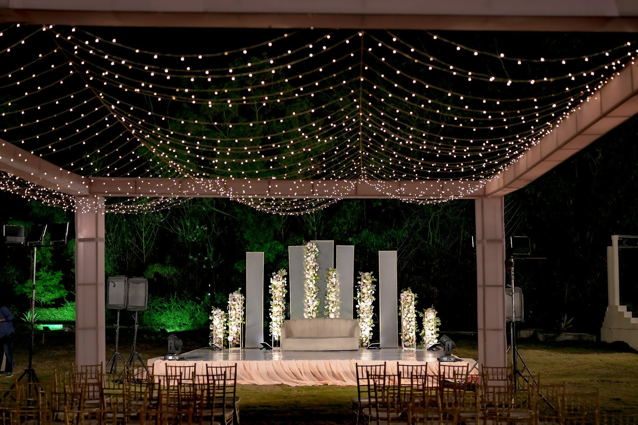 An evening garden reception under a canopy of fairy lights
